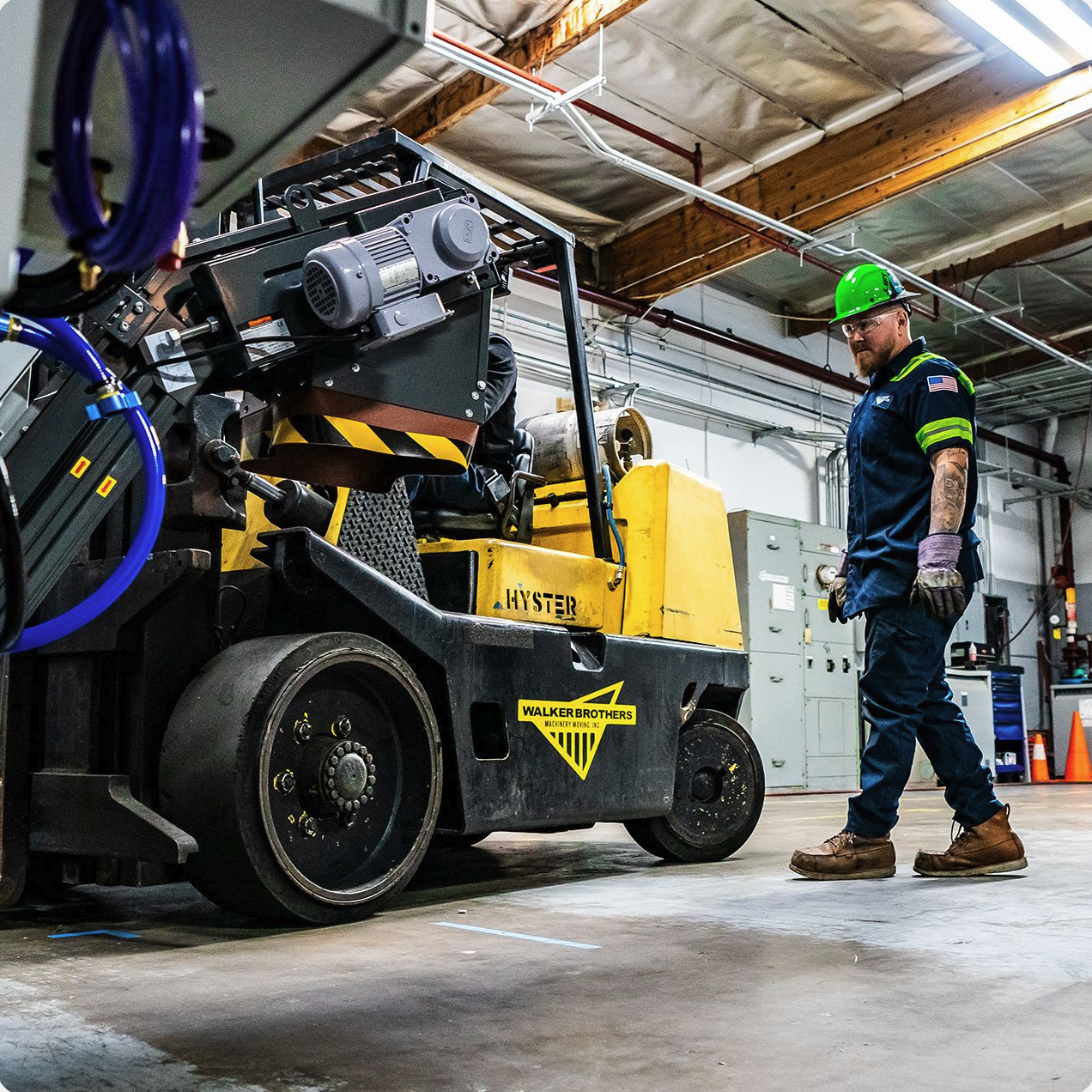 Omega Morgan Hyster forklift moving a wrapped load in a warehouse